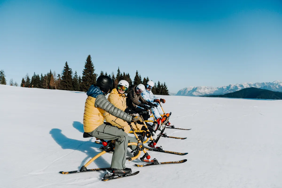 Senior Vacation Fun guests on Brenter snowbikes in Flachau